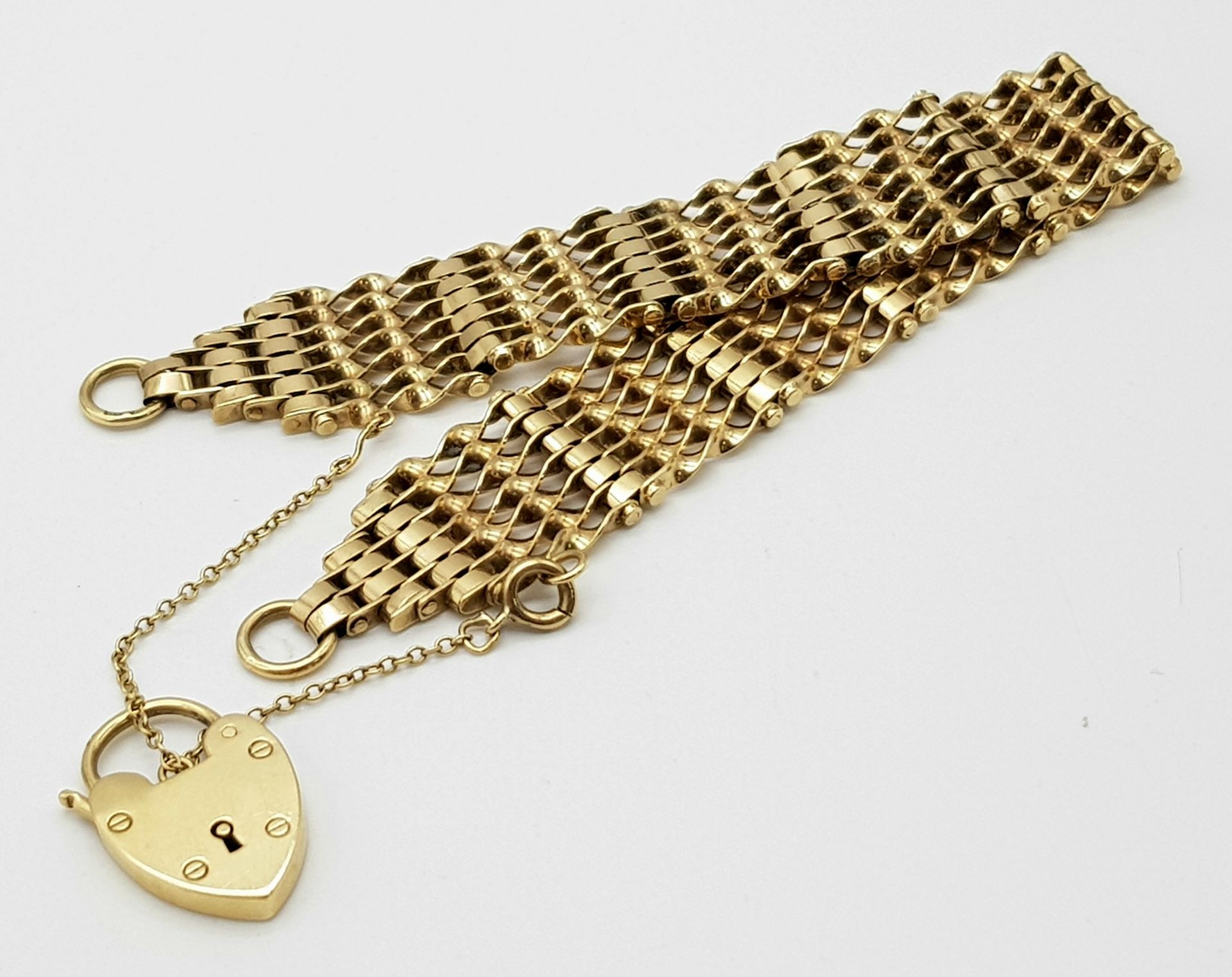 A 9K Yellow Gold gate Bracelet with Heart Clasp. 16mm width. 19.6g weight. - Image 6 of 6