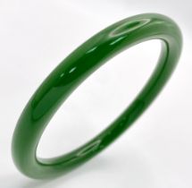 A Spinach Green Chinese Thin Jade Bangle. 7mm width. 60mm inner diameter.