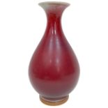 A Chinese Sang de Boeuf Glazed Vase. Markings on base. 33cm tall.