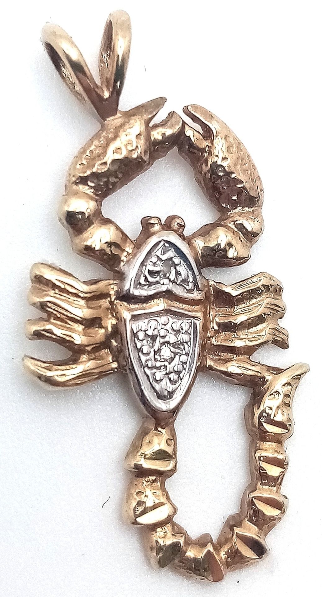 A 9K YELLOW GOLD DIAMOND SET SCORPION CHARM. 2.8cm length, 2.1g total weight. Ref: SC 8009