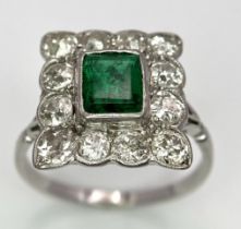 AN 18K WHITE GOLD (TESTED) EDWARDIAN OLD CUT DIAMOND AND EMERALD CLUSTER RING. 1.20CT OF OLD CUT
