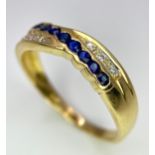 AN 18K YELLOW GOLD DIAMOND & BLUE STONE (PROBABLY SAPPHIRE) CROSSOVER RING. Size O, 2.7g total