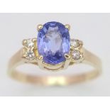 A 14K YELLOW GOLD DIAMOND & BLUE STONE RING -(PROBABLY) TANZANITE. 1.9G. SIZE L.