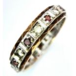 An unusual, vintage, eternity ring with alternating round cut diamonds and rubies. Size: L,