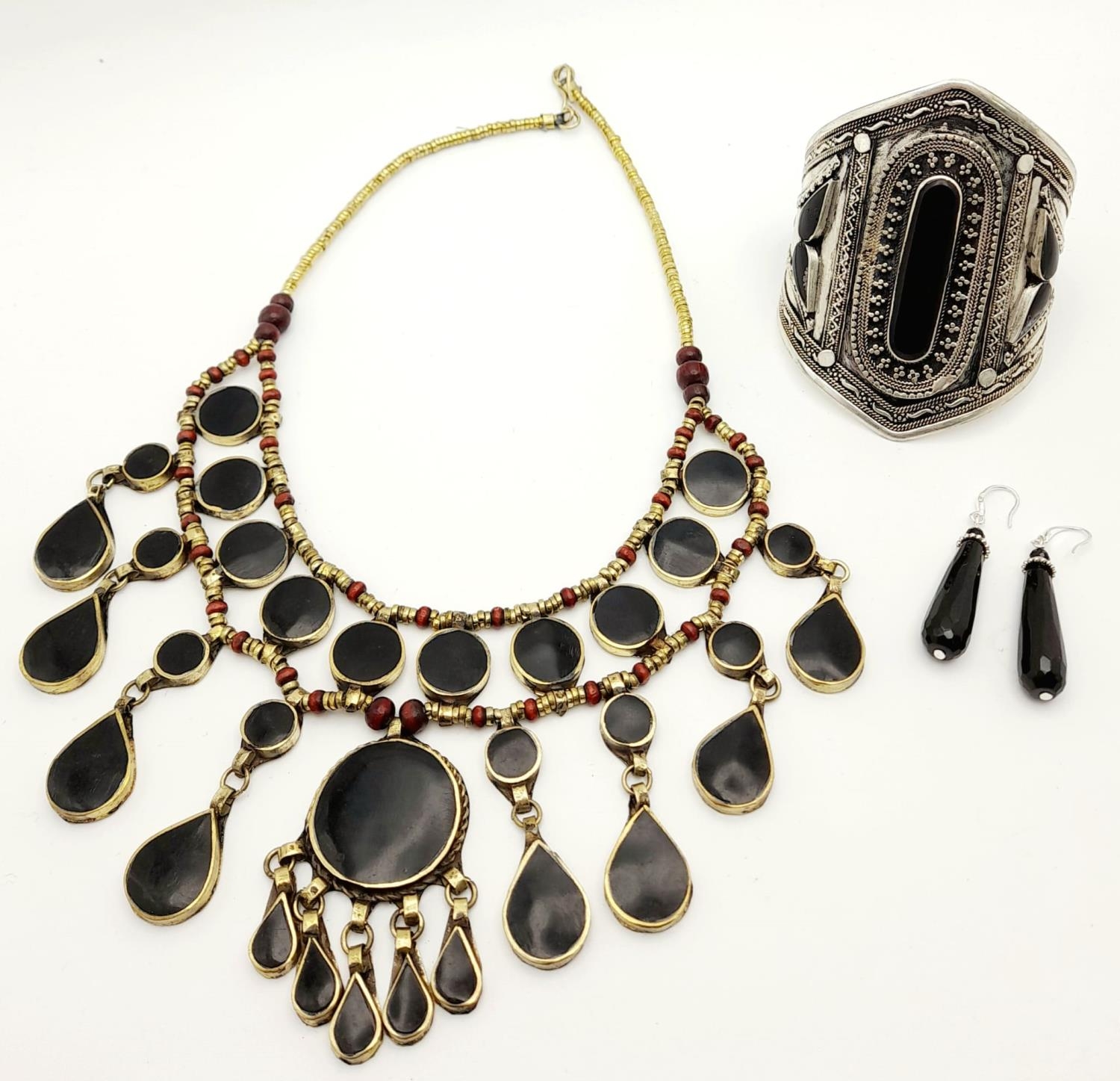 A Black Agate Jewellery Set: Cuff bangle, drop earrings and necklace - 42cm.
