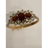 Stunning 9 carat GOLD and GARNET TRILOGY RING. Having 3 x oval and round cut Garnets set to top.