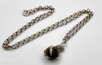 An astonishing sterling silver "ball on claw" pendant on silver belcher chain. Total weight 17.6G.