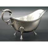 An Almost Antique Sterling Silver Gravy Boat. Scroll handle and shell decorative legs. Hallmarks for