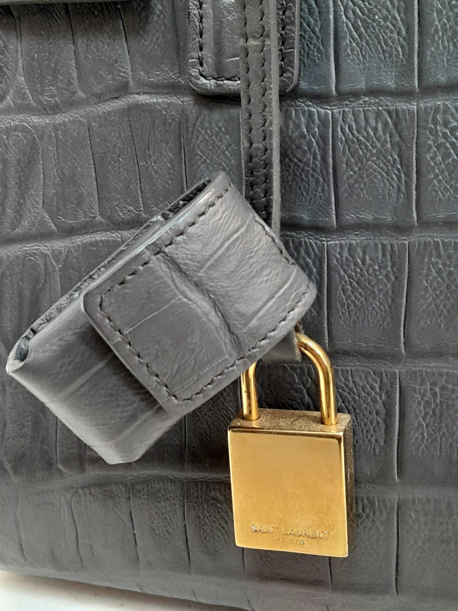 A Saint Laurent Grey Crocodile Embossed Small Sac De Jour Bag. Gold tone padlock (no key). Soft - Image 4 of 6