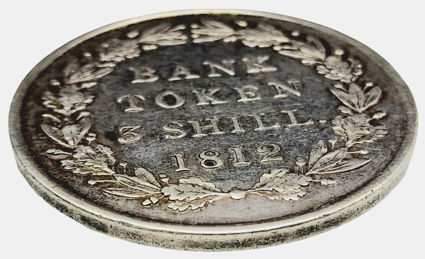 An 1812 George III Three Shilling Silver Token. Please see photos for conditions. Ref: 610001I - Image 3 of 3