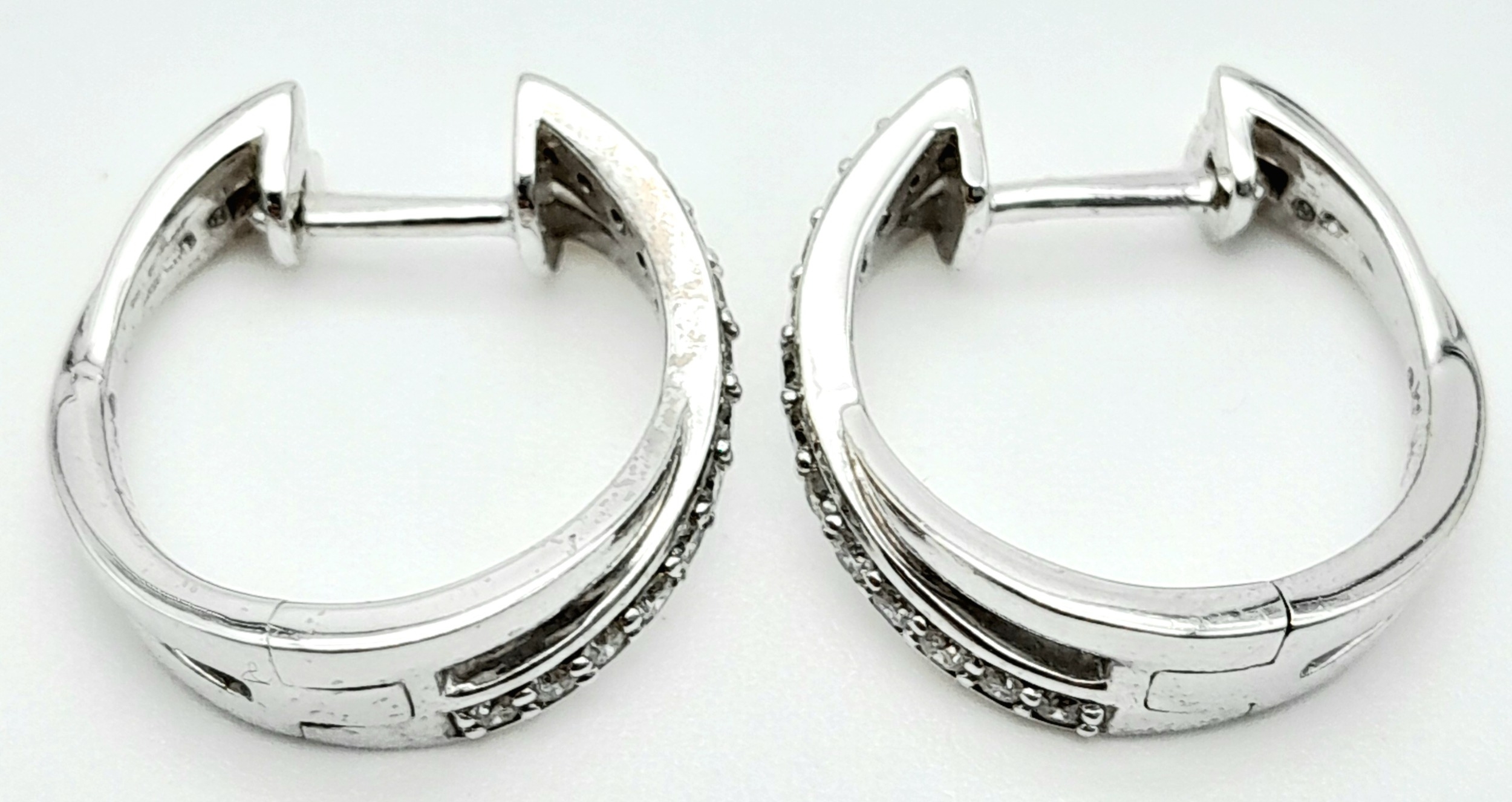 A PAIR OF 14K WHITE GOLD DIAMOND EARRINGS. 0.35ctw, 1.6cm diameter, 4.8g total weight. Ref: SC 8052 - Image 4 of 7