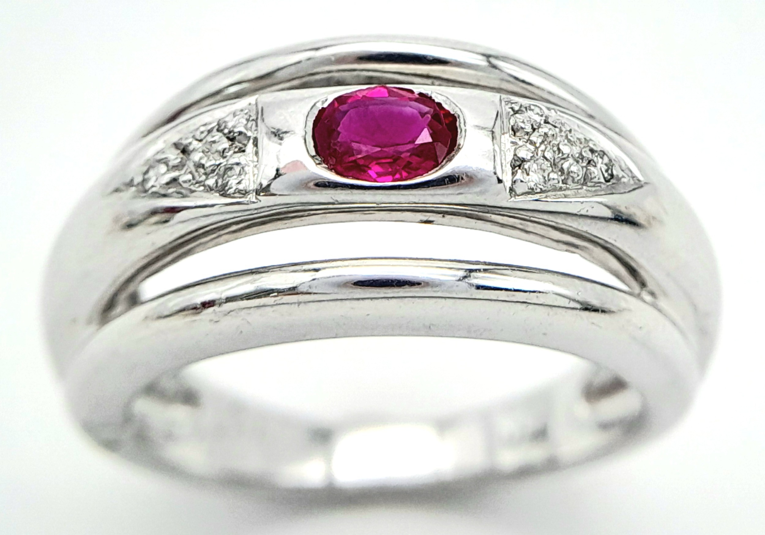AN 18K WHITE GOLD DIAMOND & RUBY RING. Size N, 6.6g total weight. Ref: SC 8068