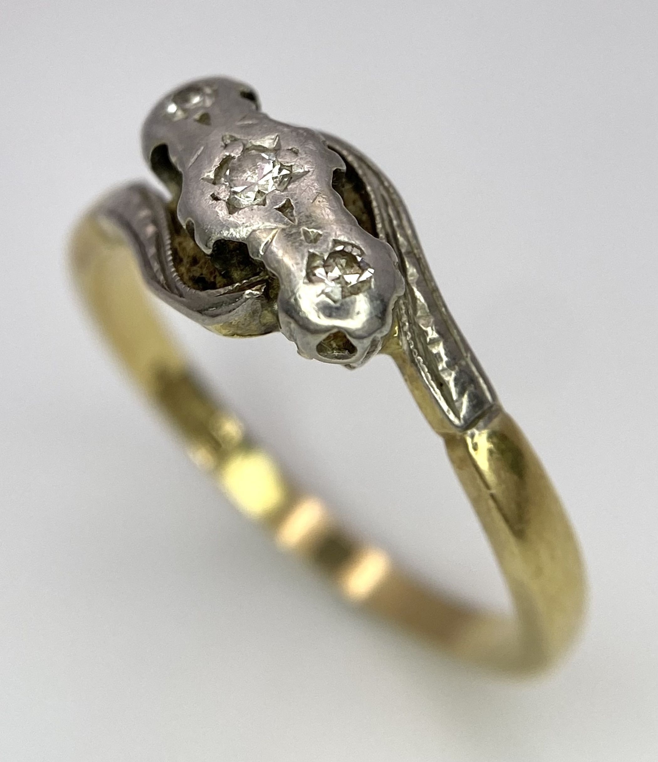 A Vintage 18K Yellow Gold, Platinum and Old Cut Diamond Crossover Ring. Three old cut gypsy-set - Image 3 of 6