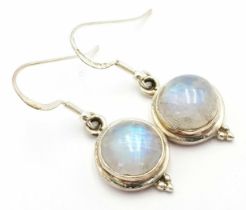 A Pair of Sterling Silver, 1cm Round Cut Cabochon Moonstone Earrings. 3.5cm Drop.