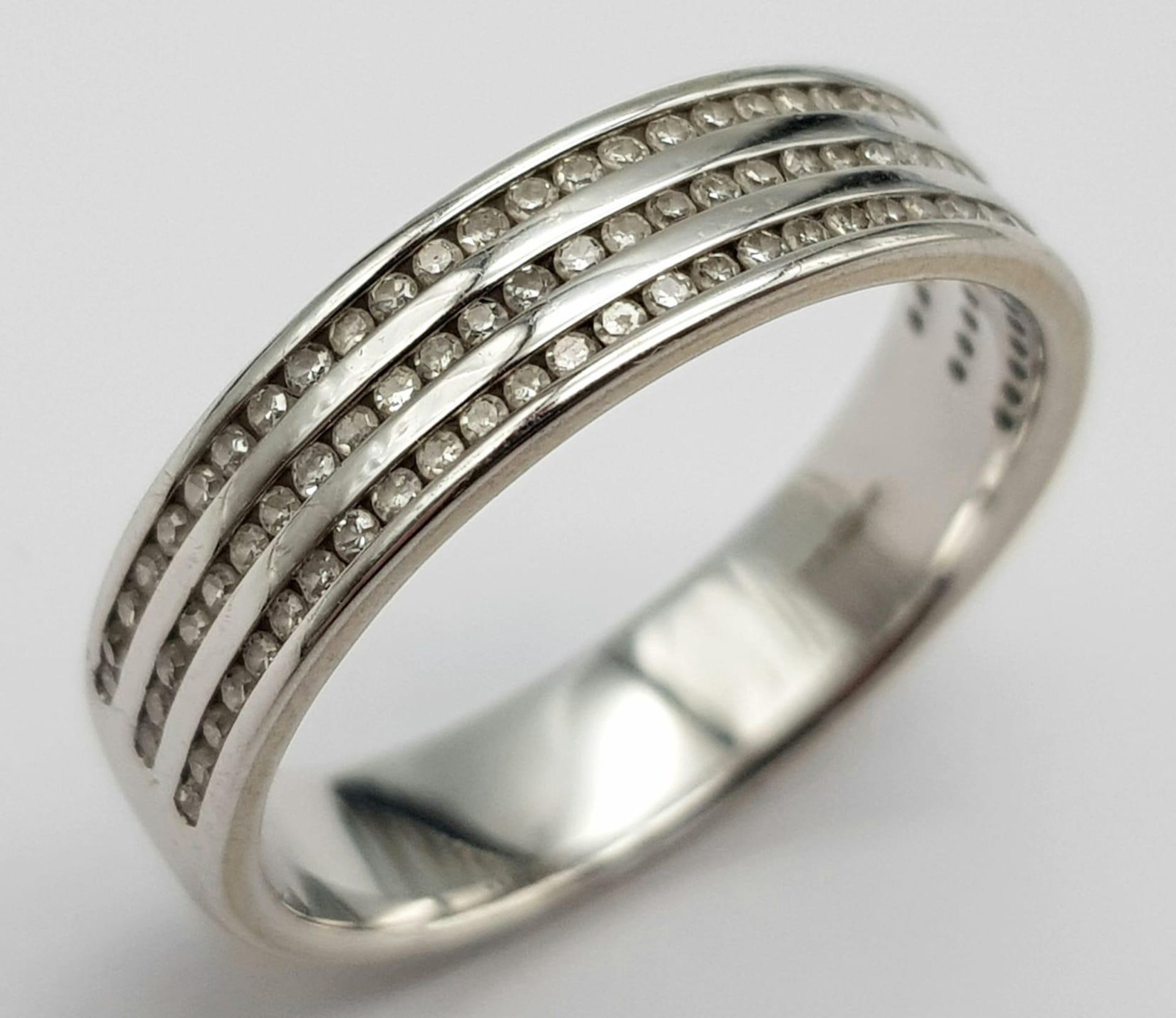 An 18K White Gold Triple Row Diamond Half Eternity Ring. 0.48ctw. Size P. 4.7g total weight.