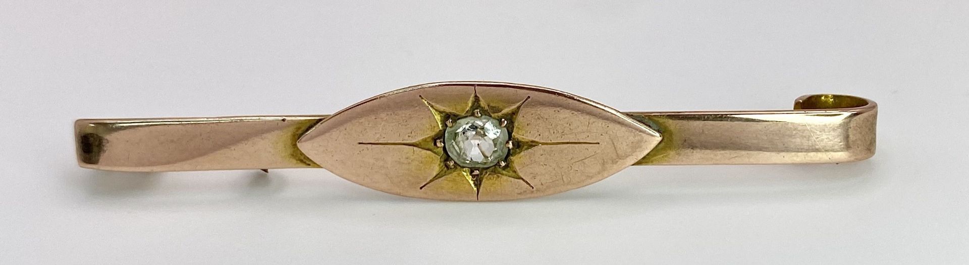 An Antique 9K Rose Gold (tested) Diamond Bar Brooch. A Gypsy set quality old cut diamond. 5.5cm. 4.