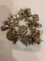 Vintage SILVER CHARM BRACELET Full of interesting and unusual charms. Please see all pictures.