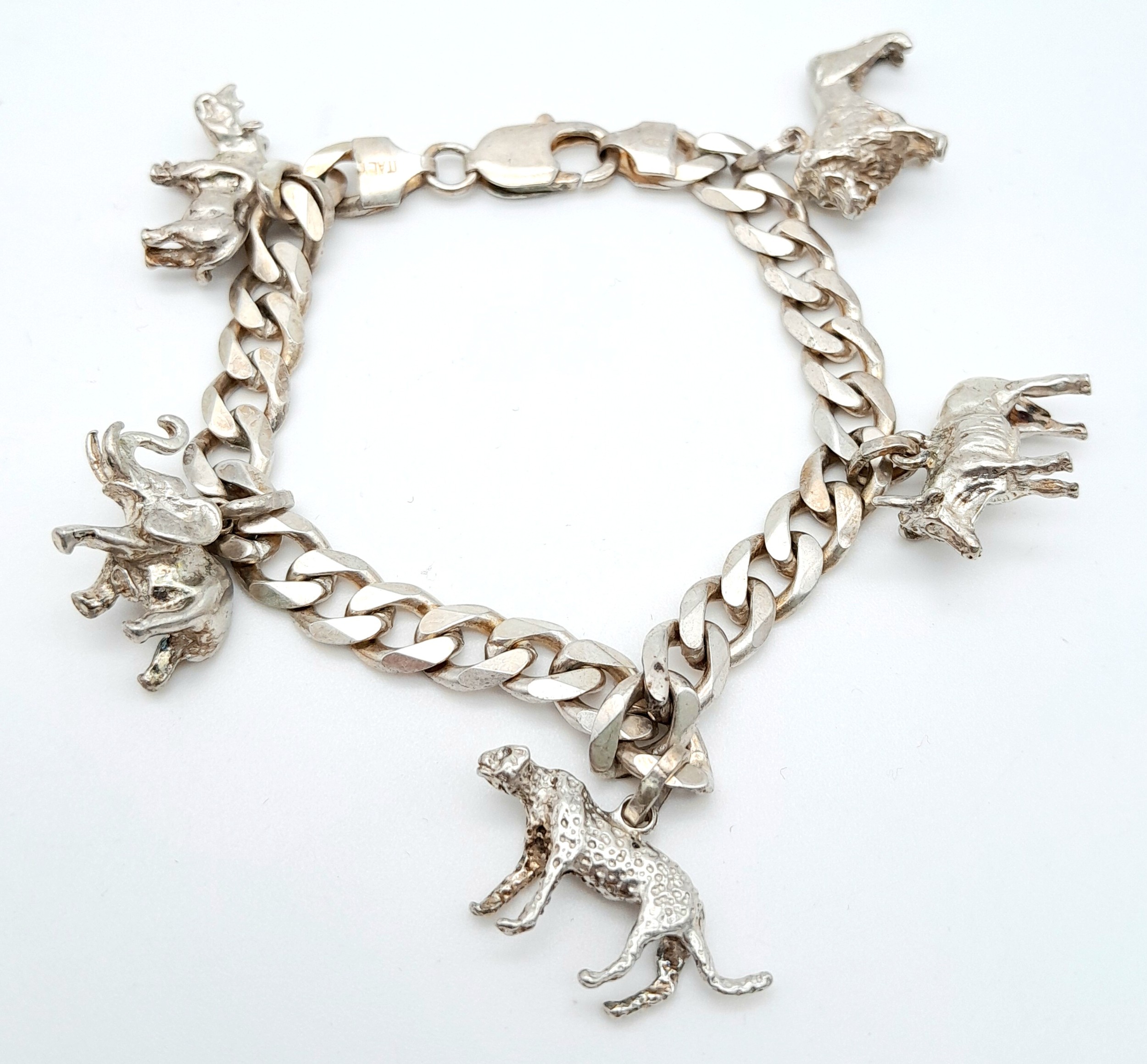 A LOVELY STARTER SILVER CHARM BRACELET WITH 5 ANIMAL CHARMS WAITING TO BE ADDED TO . 38.7gms