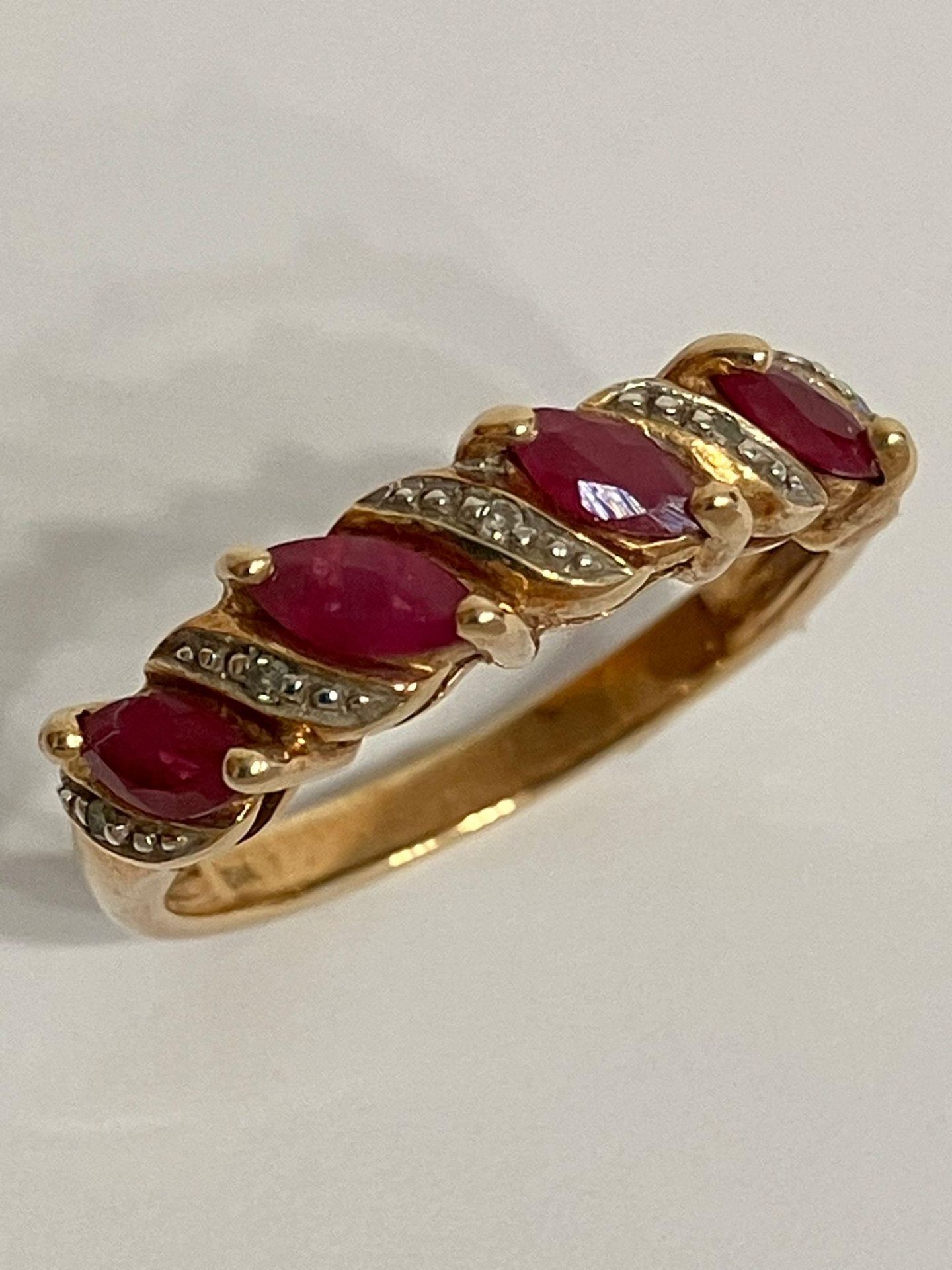 Classic 9 carat GOLD RUBY and DIAMOND RING. having Rubies and Diamonds sweep mounted. Full UK