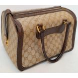 A Gucci Monogram Hard Train Vanity Case. Textile exterior with leather trim, two rolled leather