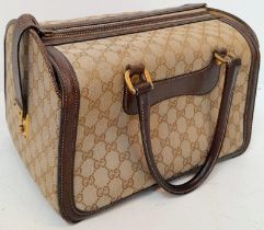 A Gucci Monogram Hard Train Vanity Case. Textile exterior with leather trim, two rolled leather