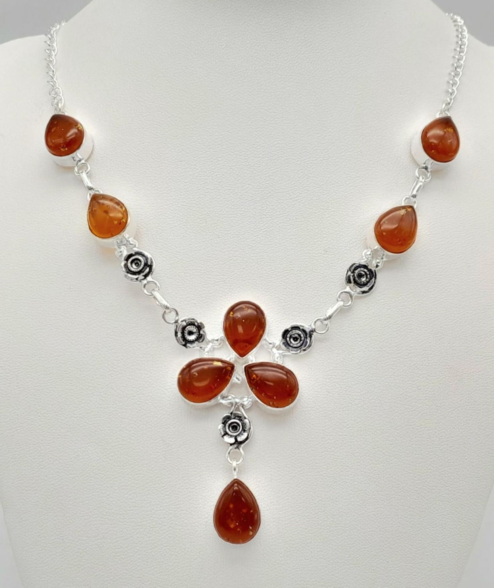 An Amber Resin Necklace set in 925 Silver. 50cm.