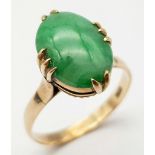 A Vintage 18K Yellow Gold Jade Ring. Oval cut jade cabochon on a four claw setting. Size R. 3.45g