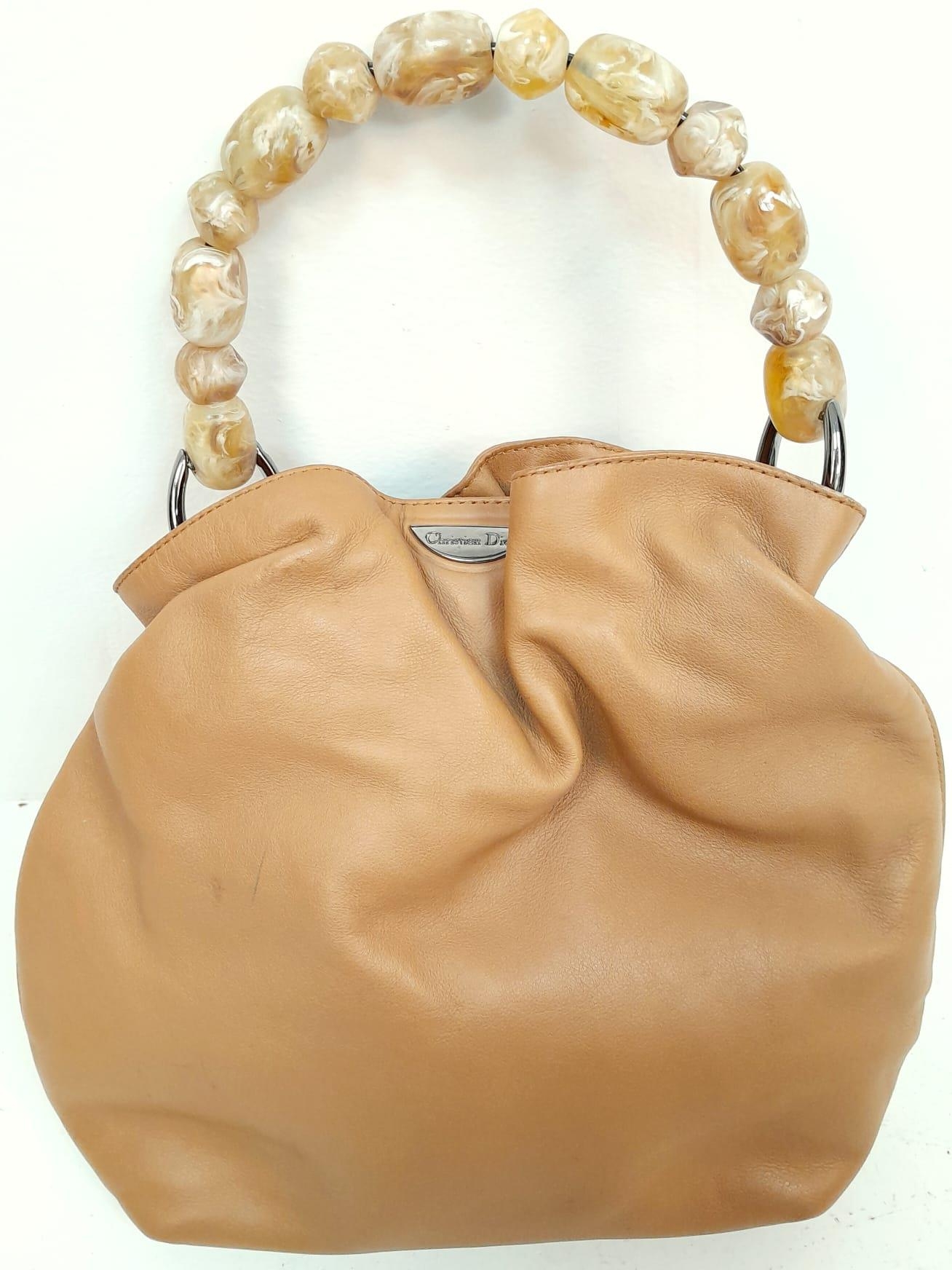 A Christian Dior Tan 'Maris' Hand Bag. Leather exterior with silver-toned hardware, beaded handle,