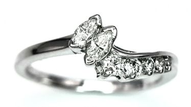 A 14K White Gold (tested) Mixed Cut Diamond Crossover Ring. Size N. 2.9g total weight.