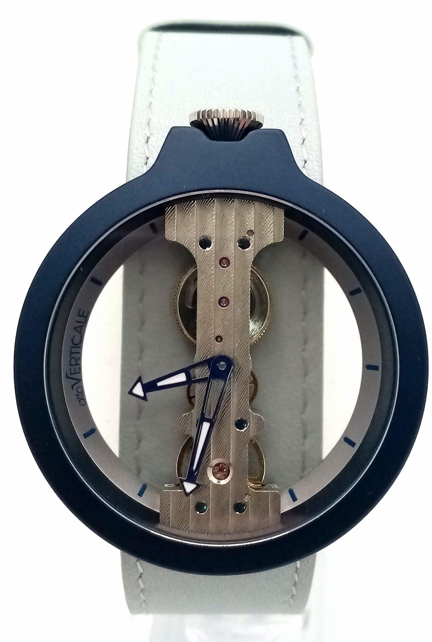A Verticale Mechanical Top Winder Unisex Watch. Turquoise strap with navy toned skeleton case. As