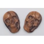 A PAIR OF TIGERS EYE CARVED MATCHING SKULLS - VERY RARE AND UNUSUAL. 20MM X 15.5MM