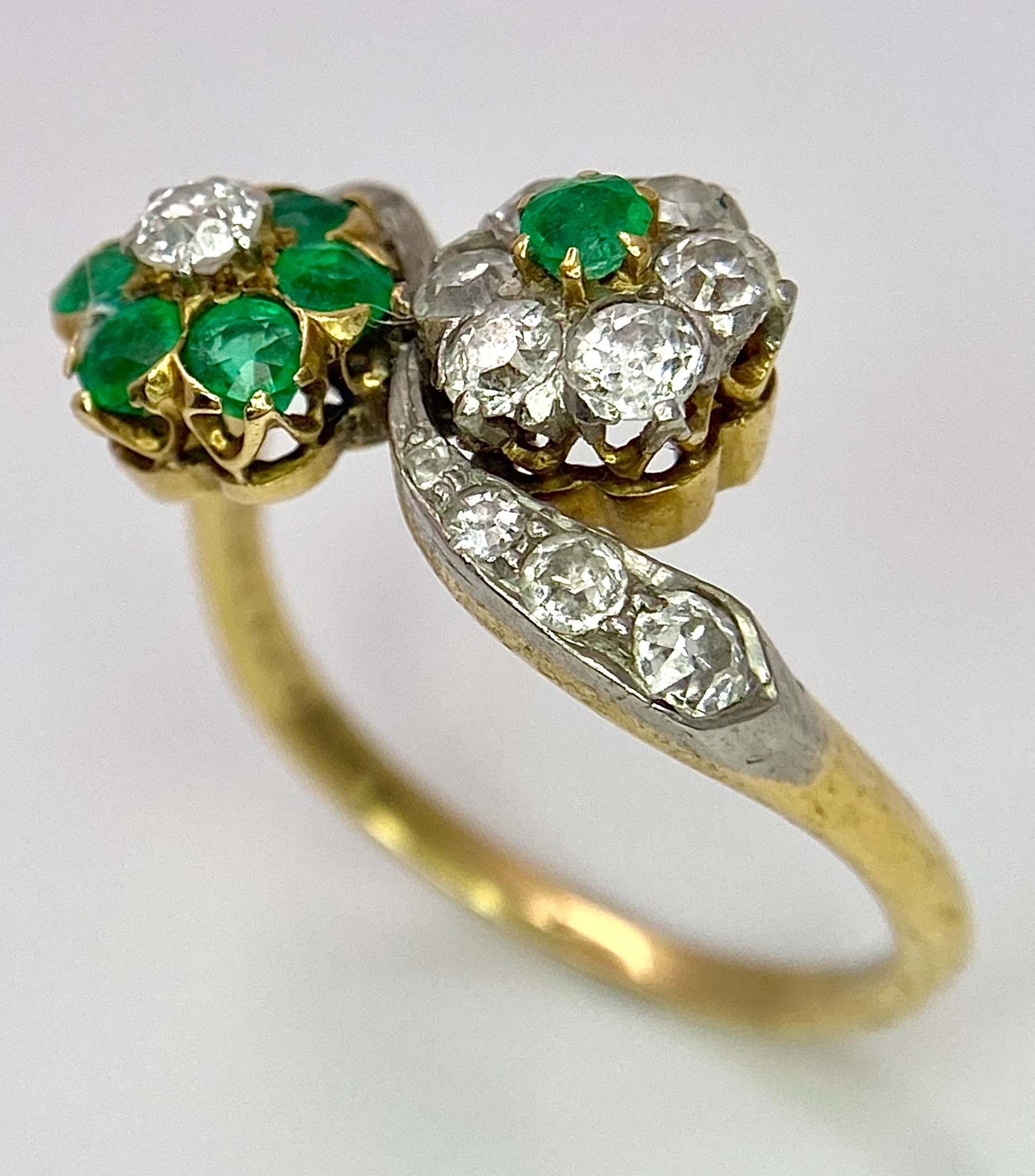 A Vintage 18K Yellow Gold, Platinum, Emerald and Diamond Crossover Ring. Reverse flowers with - Image 2 of 9