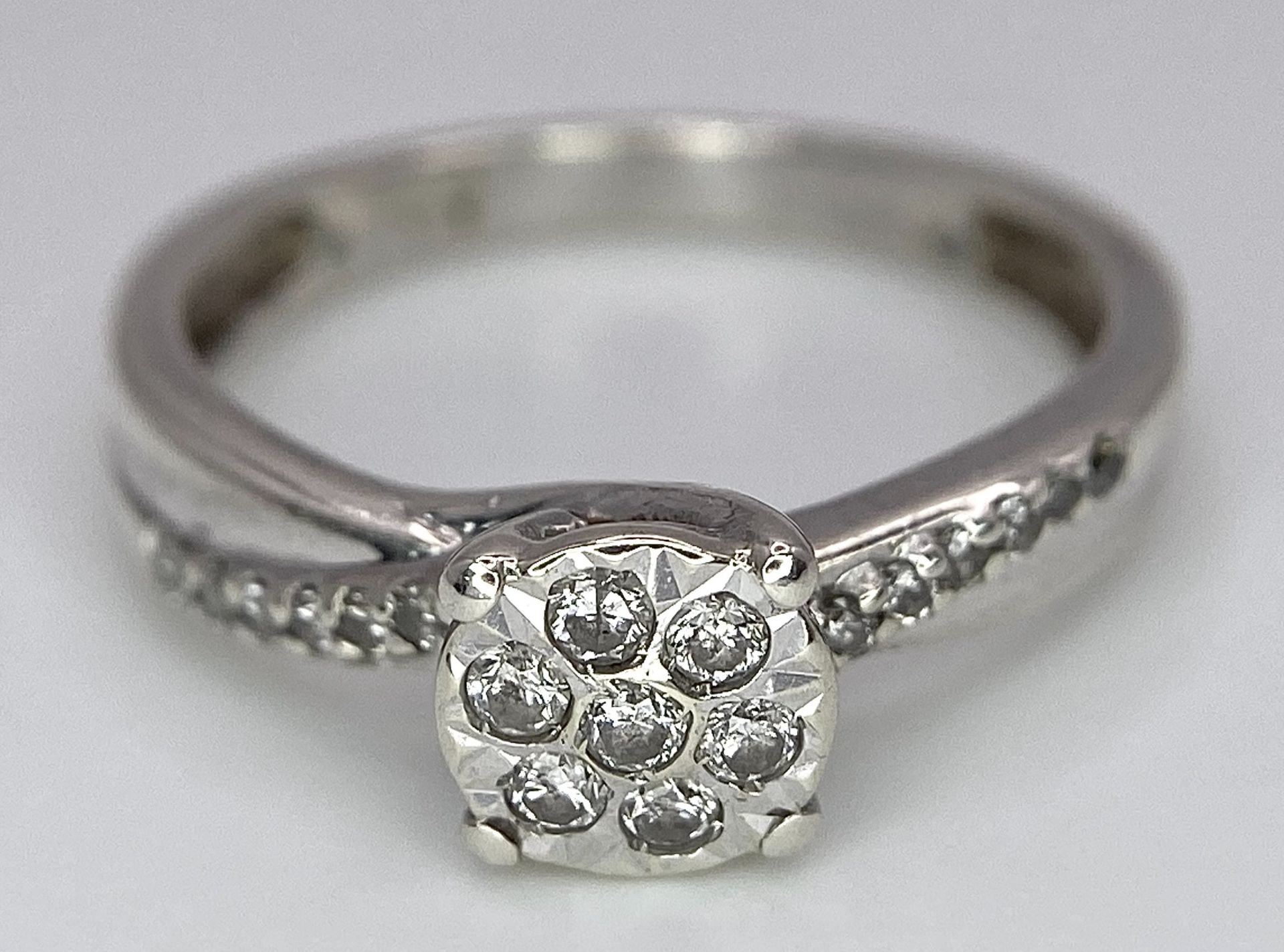 A 9K White Gold Diamond Cluster Ring. Seven small diamonds on a circular base with diamonds on - Image 5 of 6