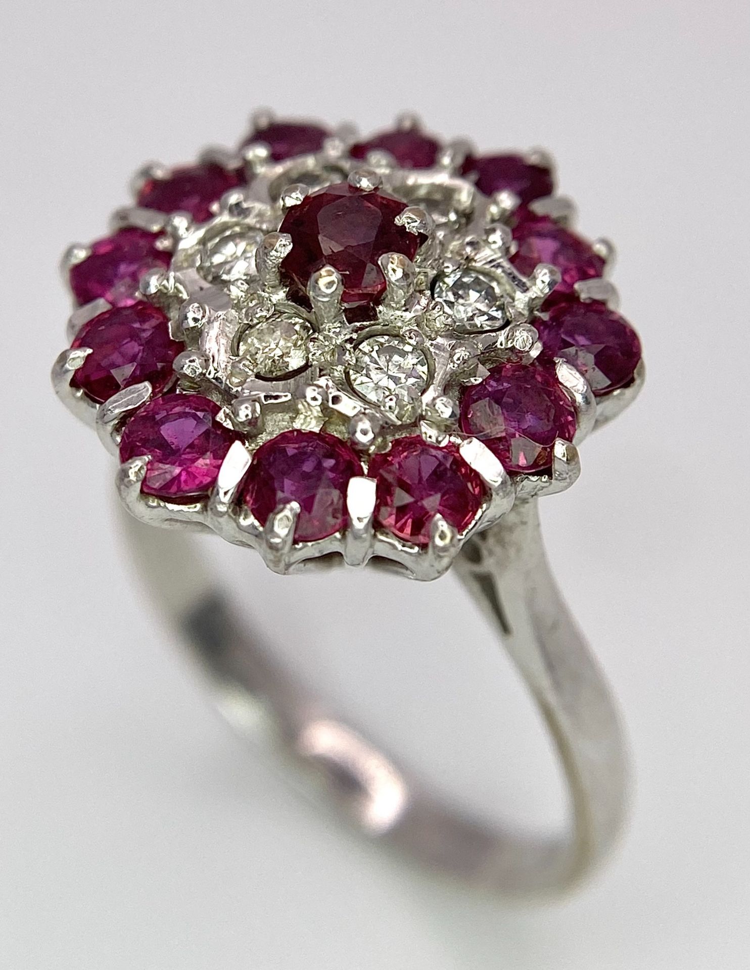 A Gorgeous 18K White Gold, Ruby and Diamond Ring. Floral design on an elevated setting. 14 rubies - Image 4 of 6