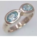 A Sterling Silver Double Aquamarine Set Ring. Size L. Set with two 6mm Oval Cut Aquamarines. The