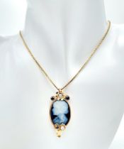 A Beautiful 9K Gold, Cameo Pendant with Sapphire and Diamond decoration on a 9K link chain.