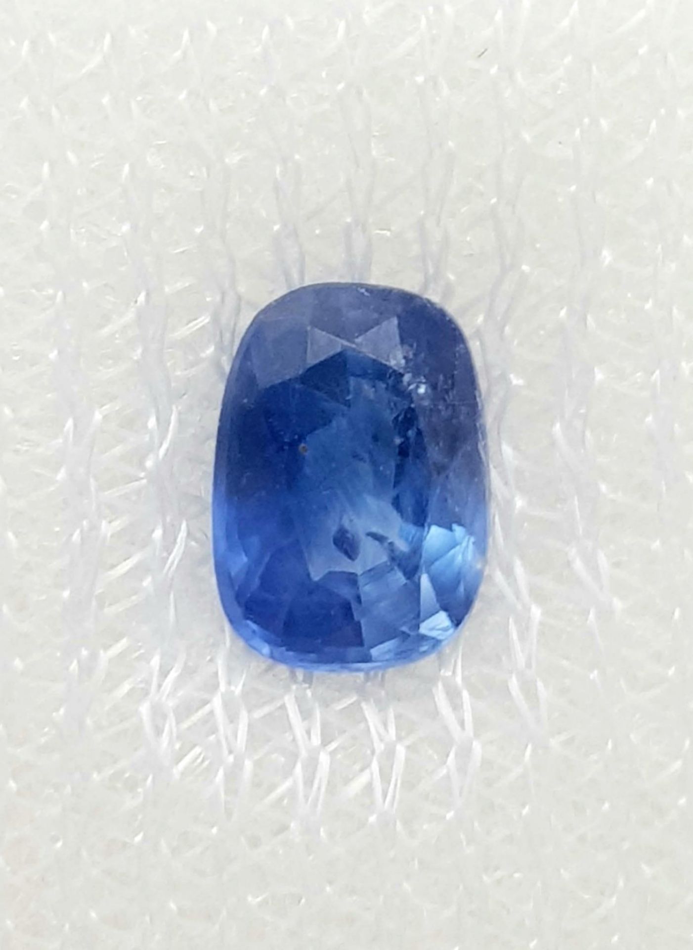 A 0.96ct Madagascan Blue Sapphire Gemstone - AIG Certified in a sealed container.