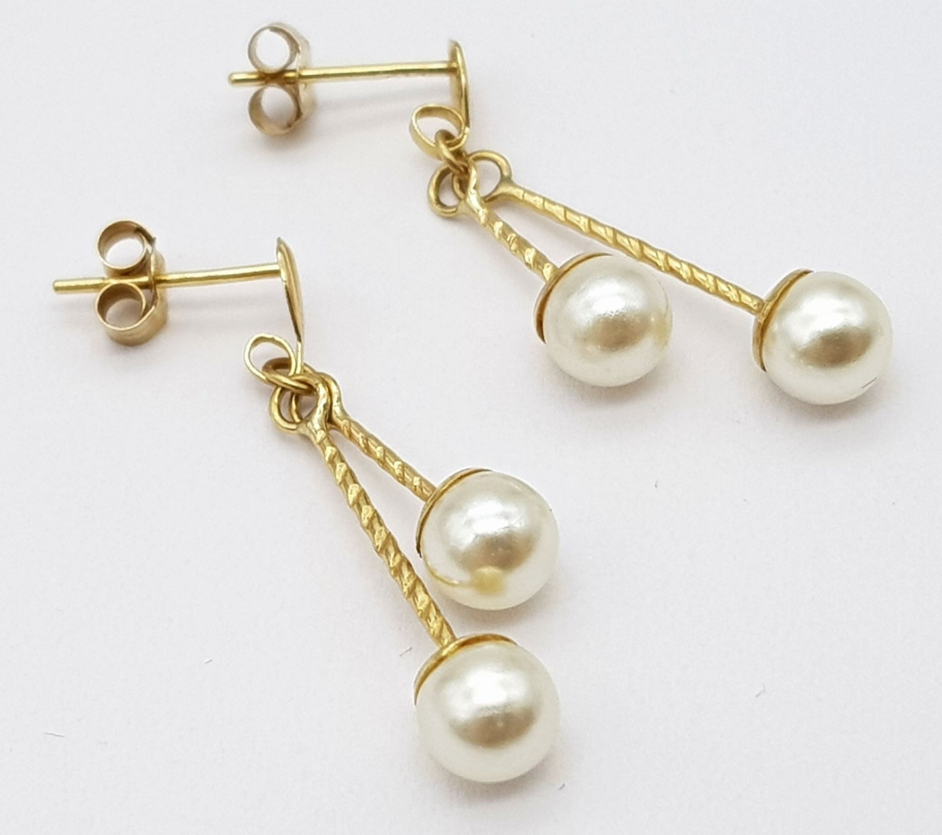 A 9ct Yellow Gold Double Drop Pearl Studs, 4mm pearl size, 0.9g weight, approx 2.5cm drop ref: