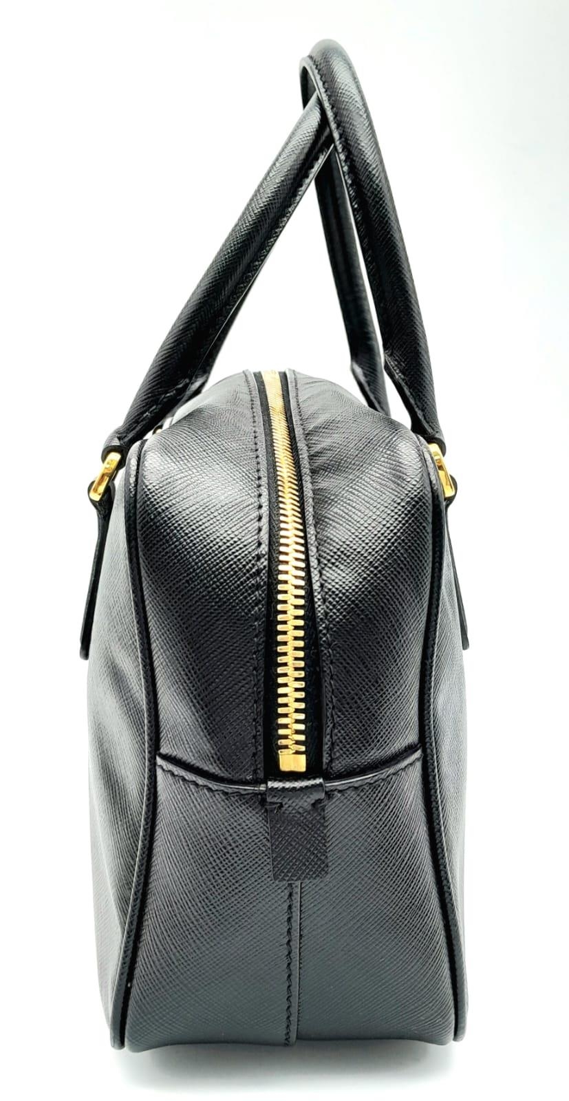 A Prada Black Bauletto Handbag. Saffiano leather exterior with gold-toned hardware, padlock, 2 - Image 2 of 11