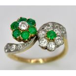 A Vintage 18K Yellow Gold, Platinum, Emerald and Diamond Crossover Ring. Reverse flowers with