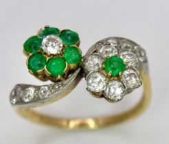 A Vintage 18K Yellow Gold, Platinum, Emerald and Diamond Crossover Ring. Reverse flowers with