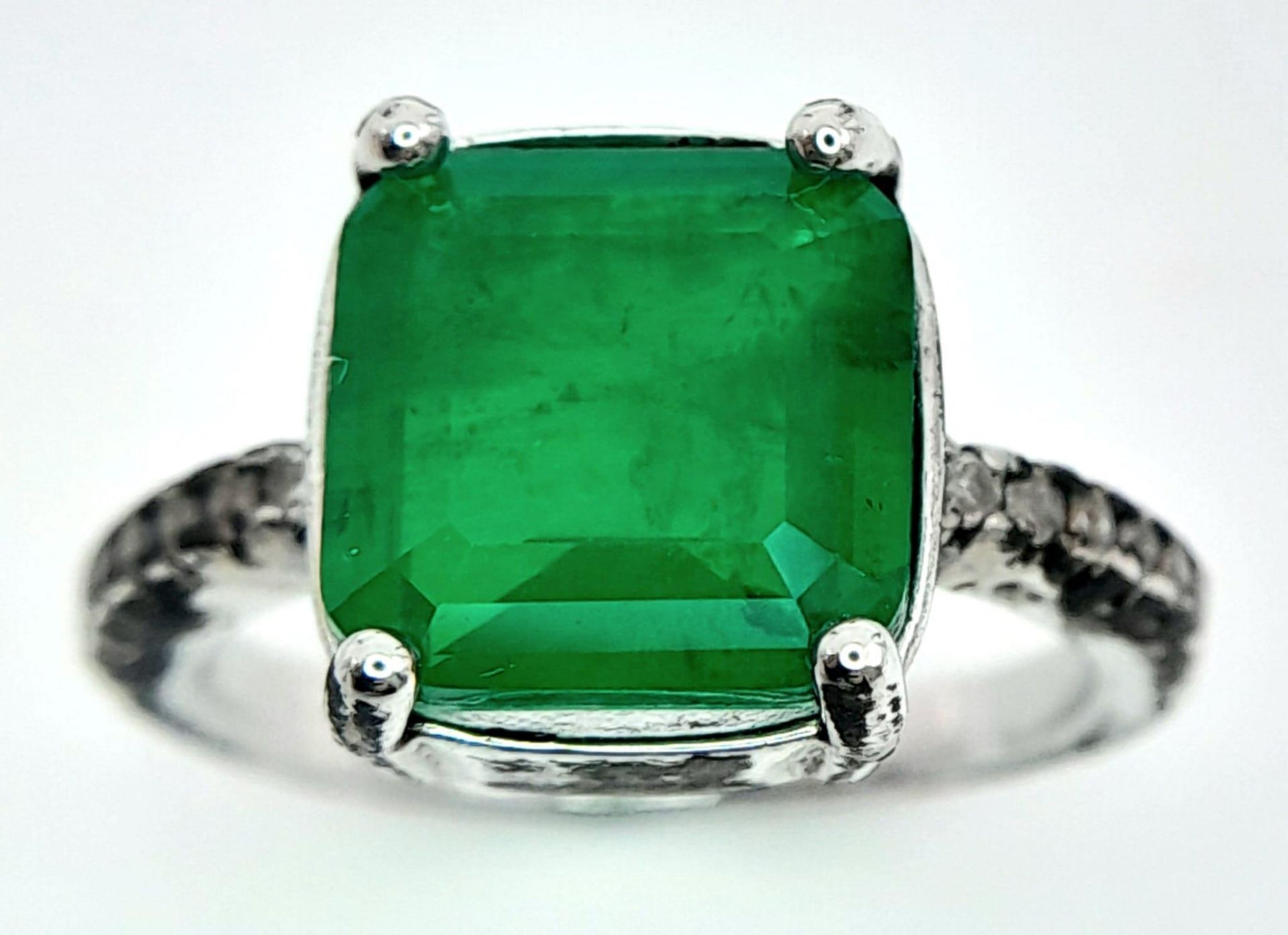 A sterling silver ring with an emerald cut green stone and cubic zirconia on the shoulders. Size: N, - Image 4 of 7