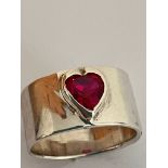 Vintage SILVER and RUBY SOLITAIRE RING.Having a heart shaped RUBY set to top on a wide SILVER band