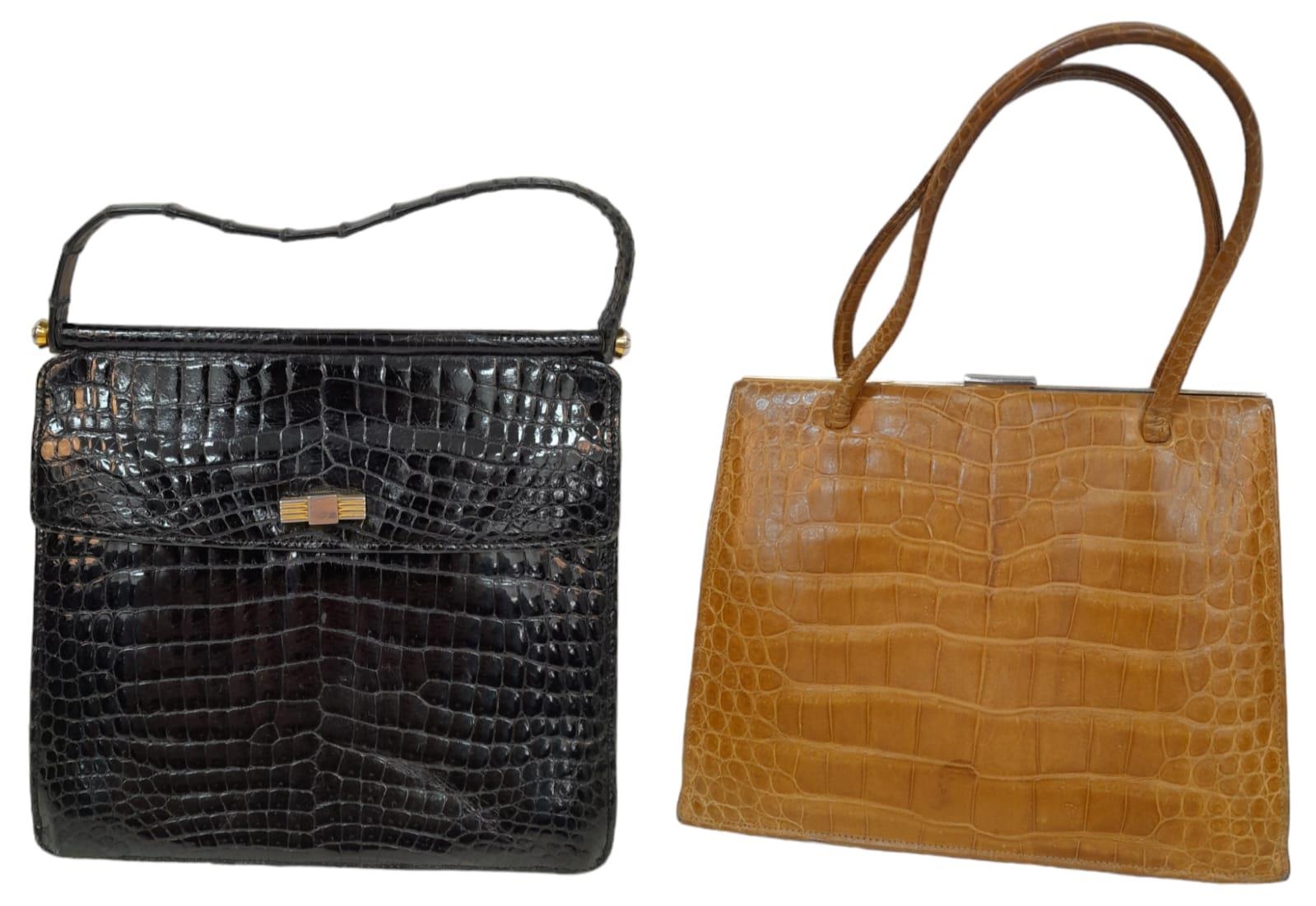 Two Crocodile Leather Hand Bags. Black crocodile bag has gold-toned hardware, a single strap and