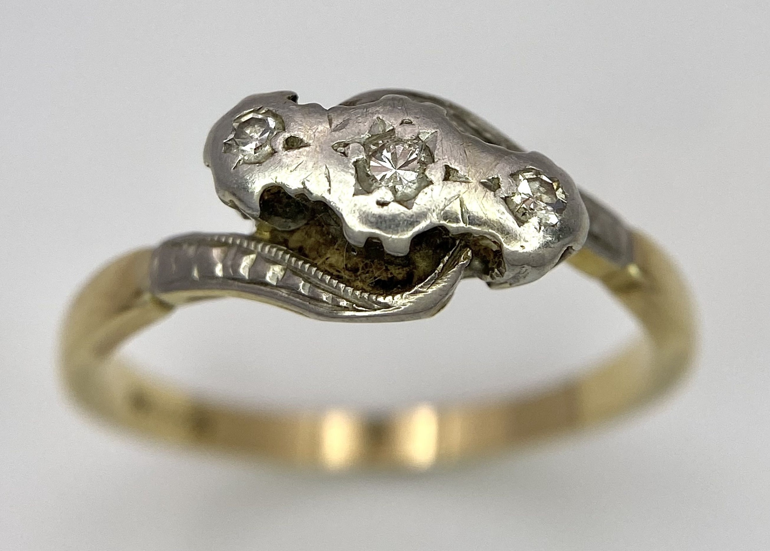 A Vintage 18K Yellow Gold, Platinum and Old Cut Diamond Crossover Ring. Three old cut gypsy-set - Image 2 of 6