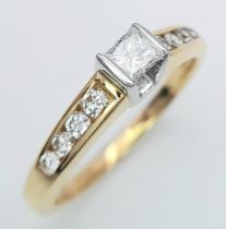 An 18K Yellow Gold Princess Cut Diamond Ring. 0.30ct central diamond with four graduated round cut