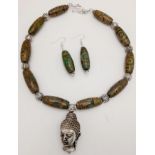 A Tibetan silver, Buddhist, necklace and earrings set with light coloured, three eyed, agate, DZI
