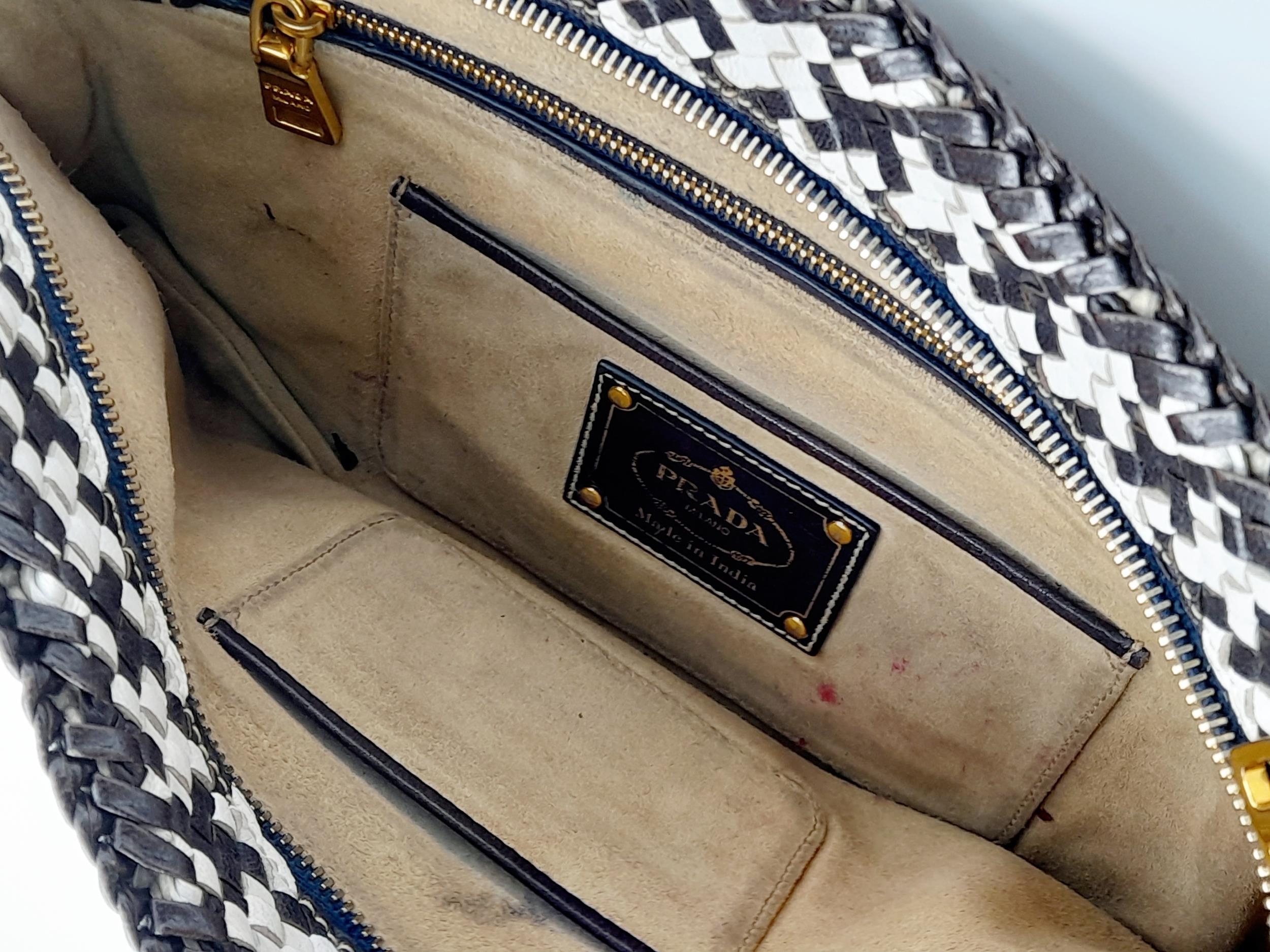 A Prada Black and White 'Madras' Clutch Bag. Woven leather exterior with gold-toned hardware and - Image 8 of 9