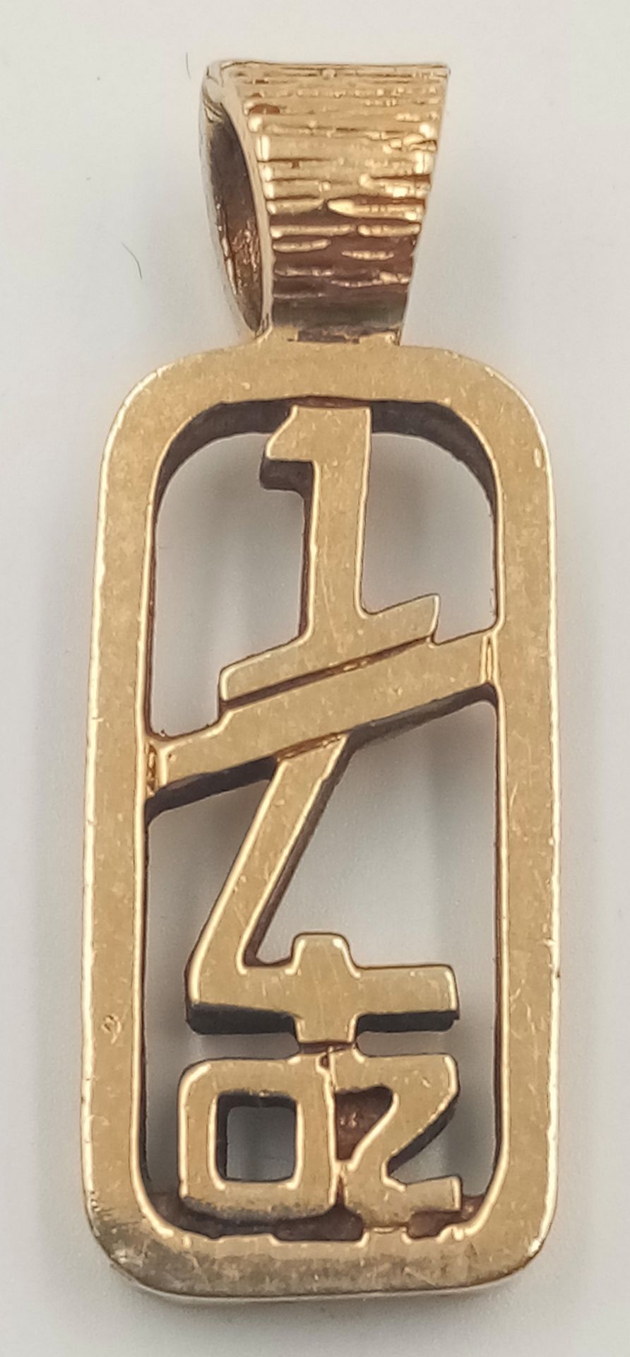 A 9K yellow gold pendant in the shape of "1/4 OZ", length (with bail): 35mm, total weight: 8.6g.