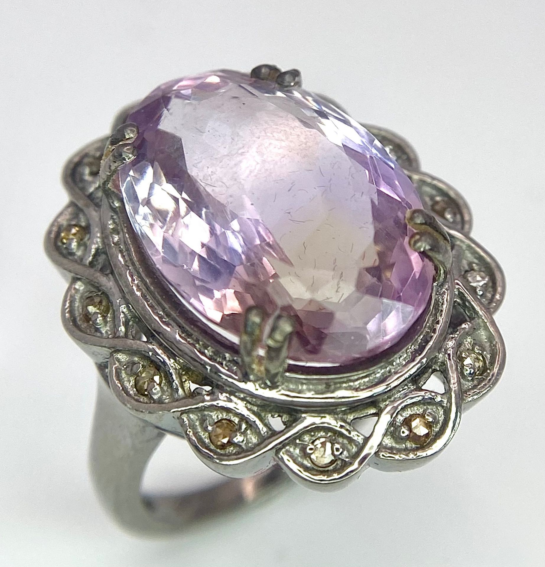 An 11.65ct Amethyst Ring with 0.25ctw of Diamond Accents. Set in 925 Silver. Size N. 9.4g total